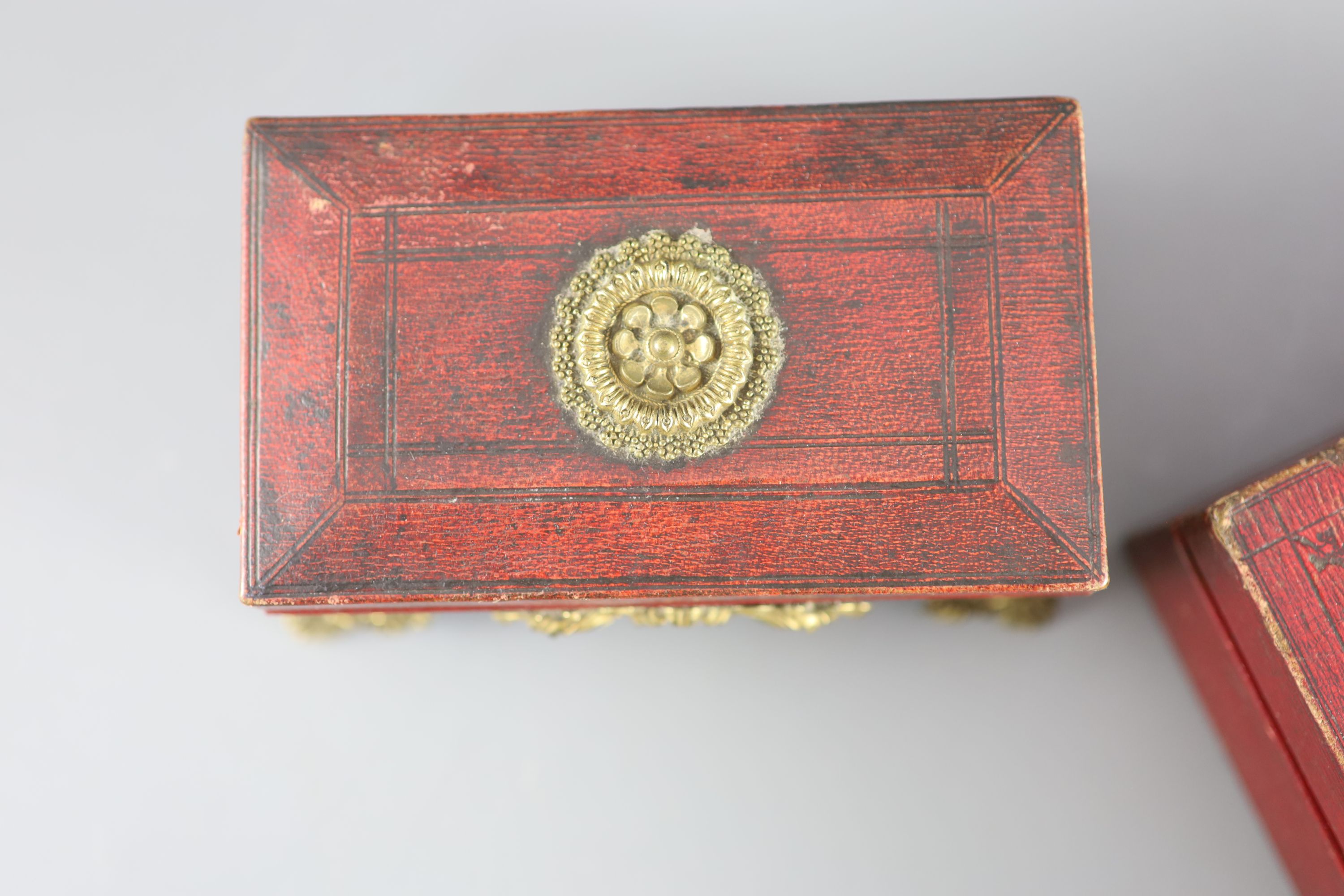 Two early 19th century red leather work boxes with assorted fittings